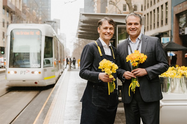 Cancer Council Victoria CEO Todd Harper with Yarra Trams COO Paul D’Alessio stopped by the Williams Street tram stop flower stall.  